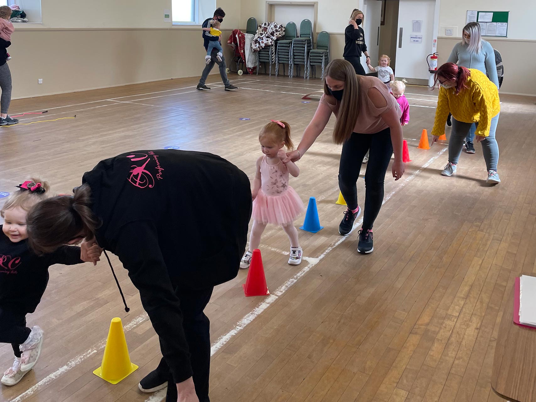girls learning ballet with parents